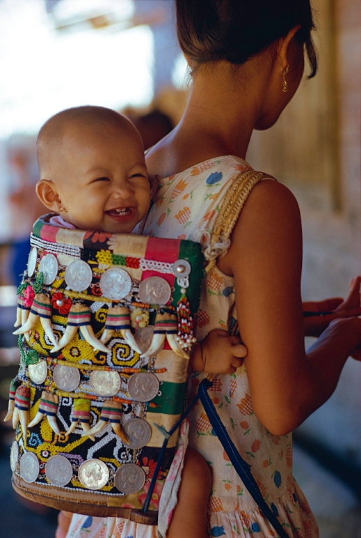 Kenyah woman with baby in a traditional carrier, Kalimantan, Borneo, Indonesia, Asia
